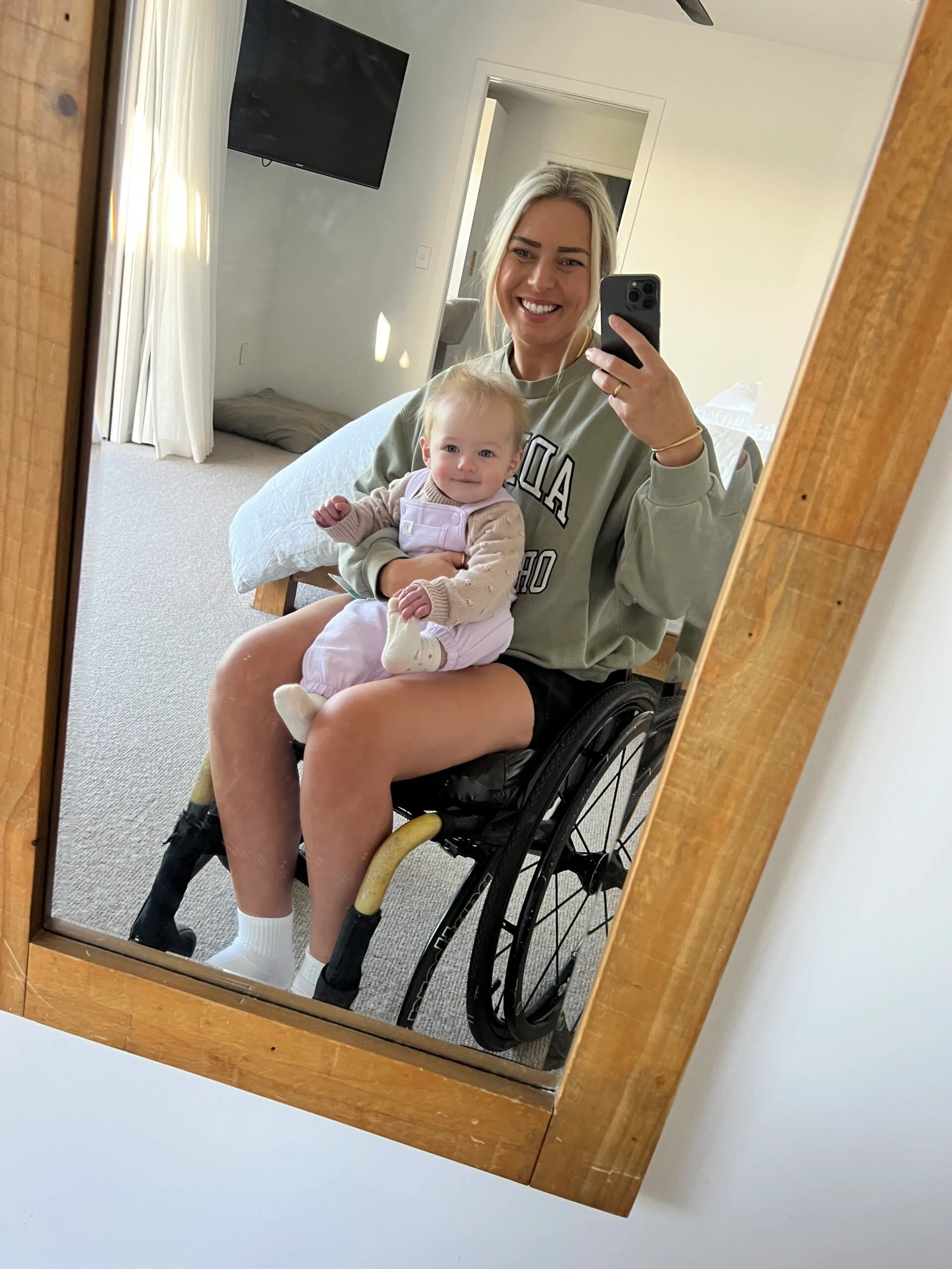 mother in wheelchair holding baby
