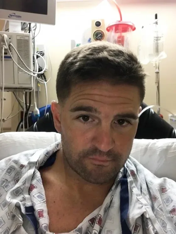 a man in hospital wearing a gown, he had wires attached to him