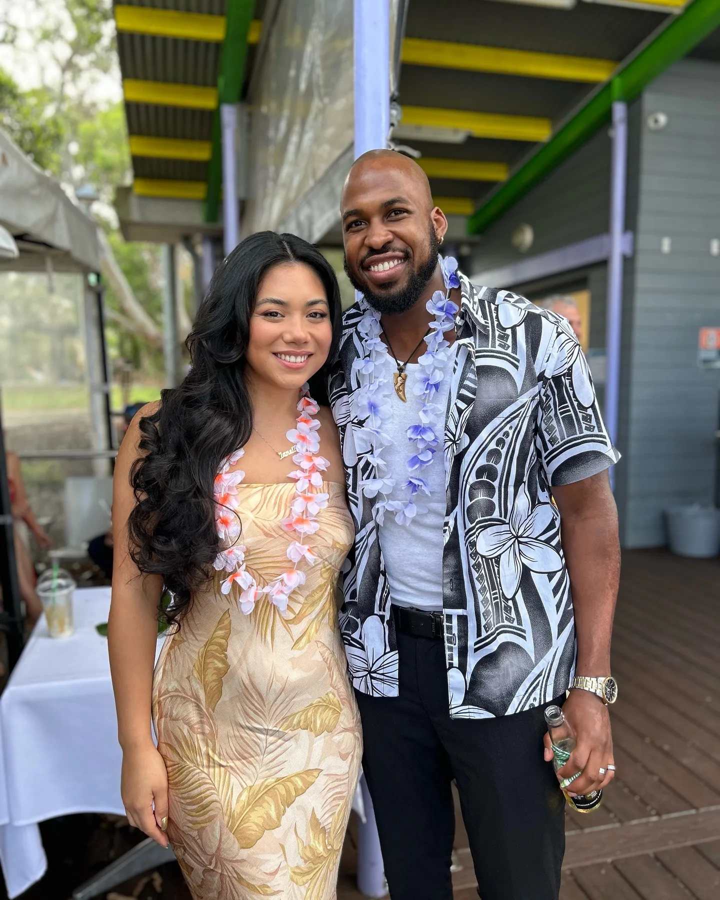 Image of happy couple dressed fancy with flower necklace