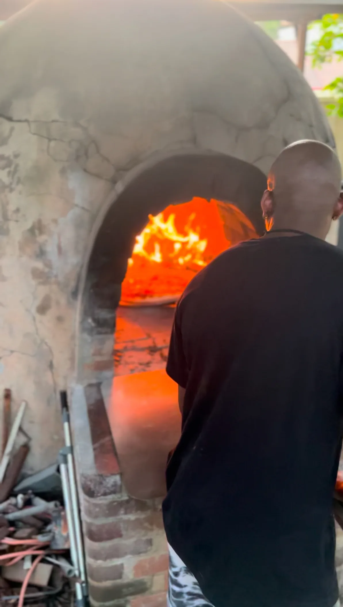 Image of man cooking in pizza oven