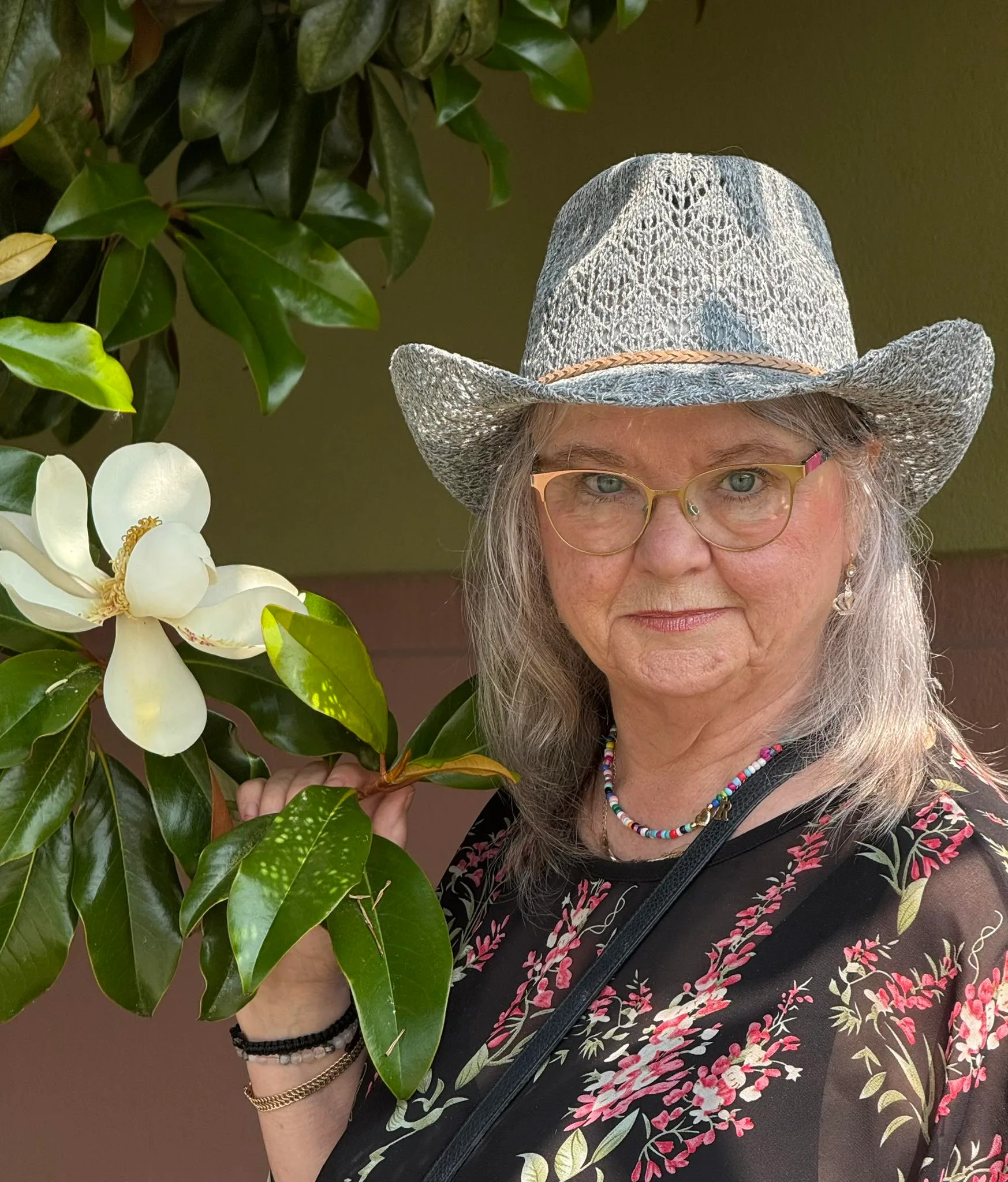 Image of woman wearing glasses and cowboy hat