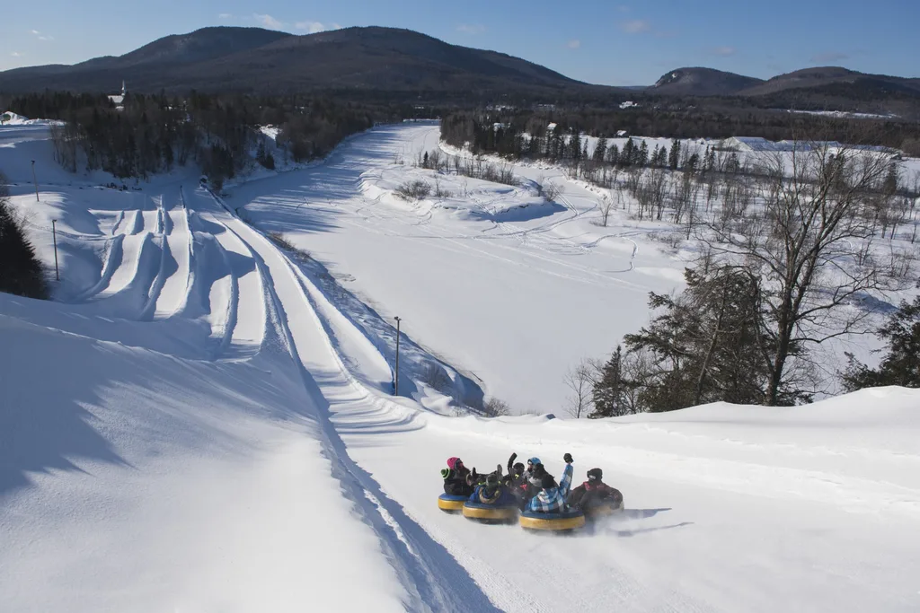 Image of people tubing on snow fields in Quebec Canada