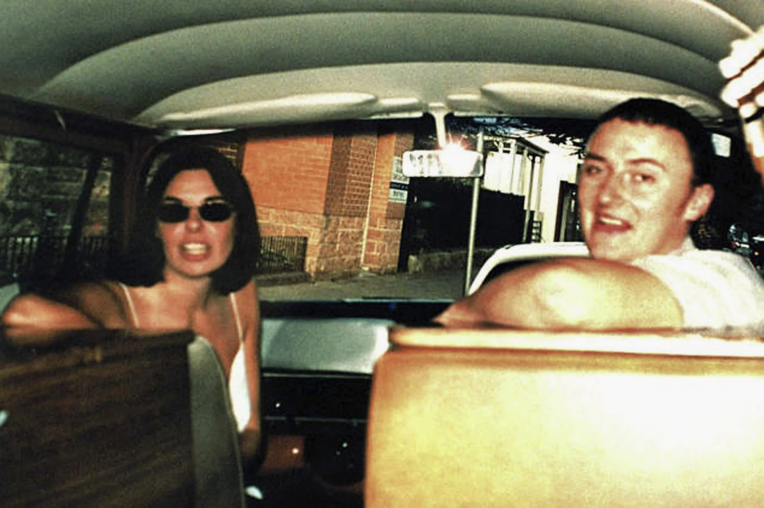 girl in flasses and man in comi van