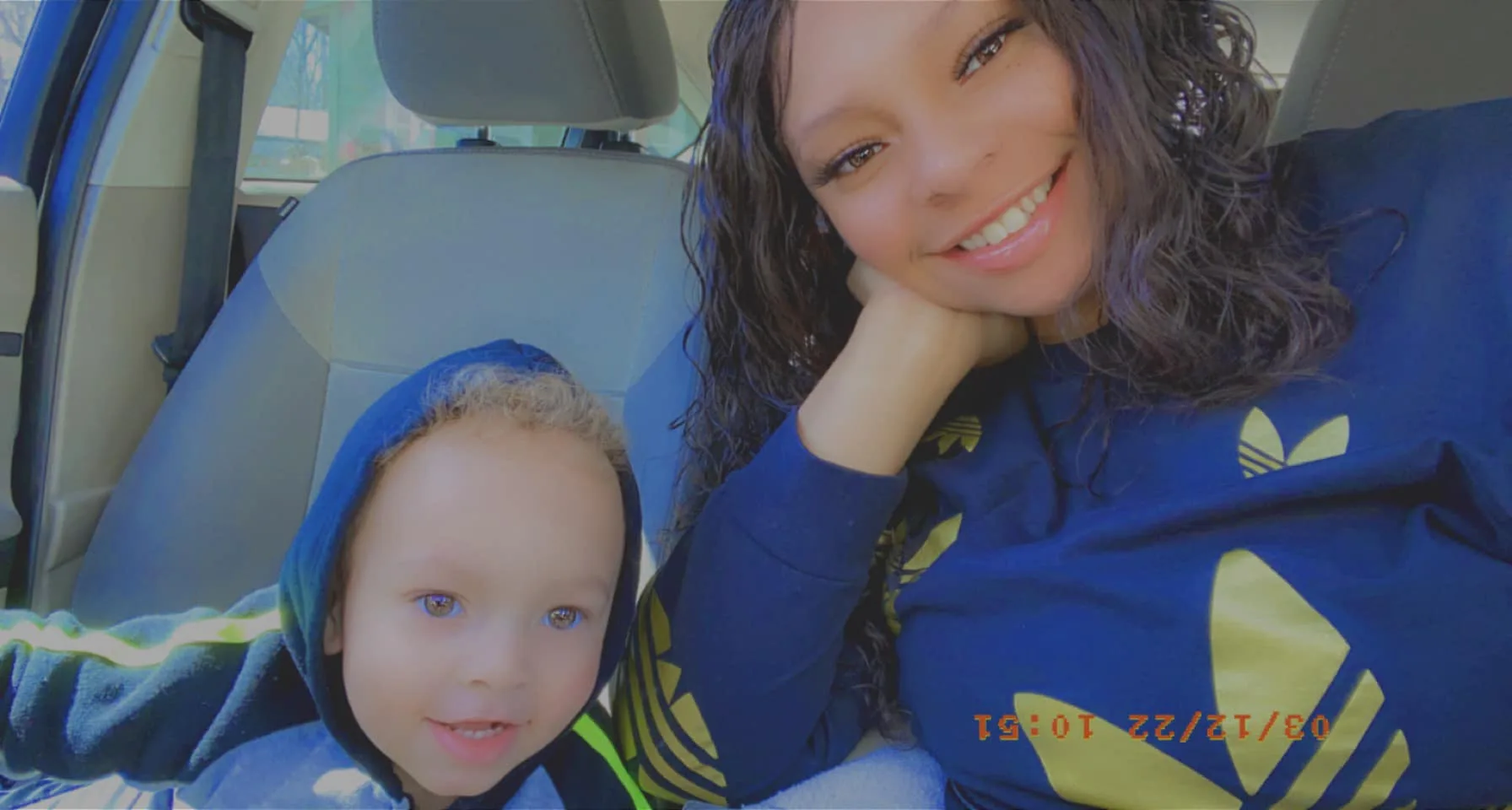 Kristian and his mum smiling in the car