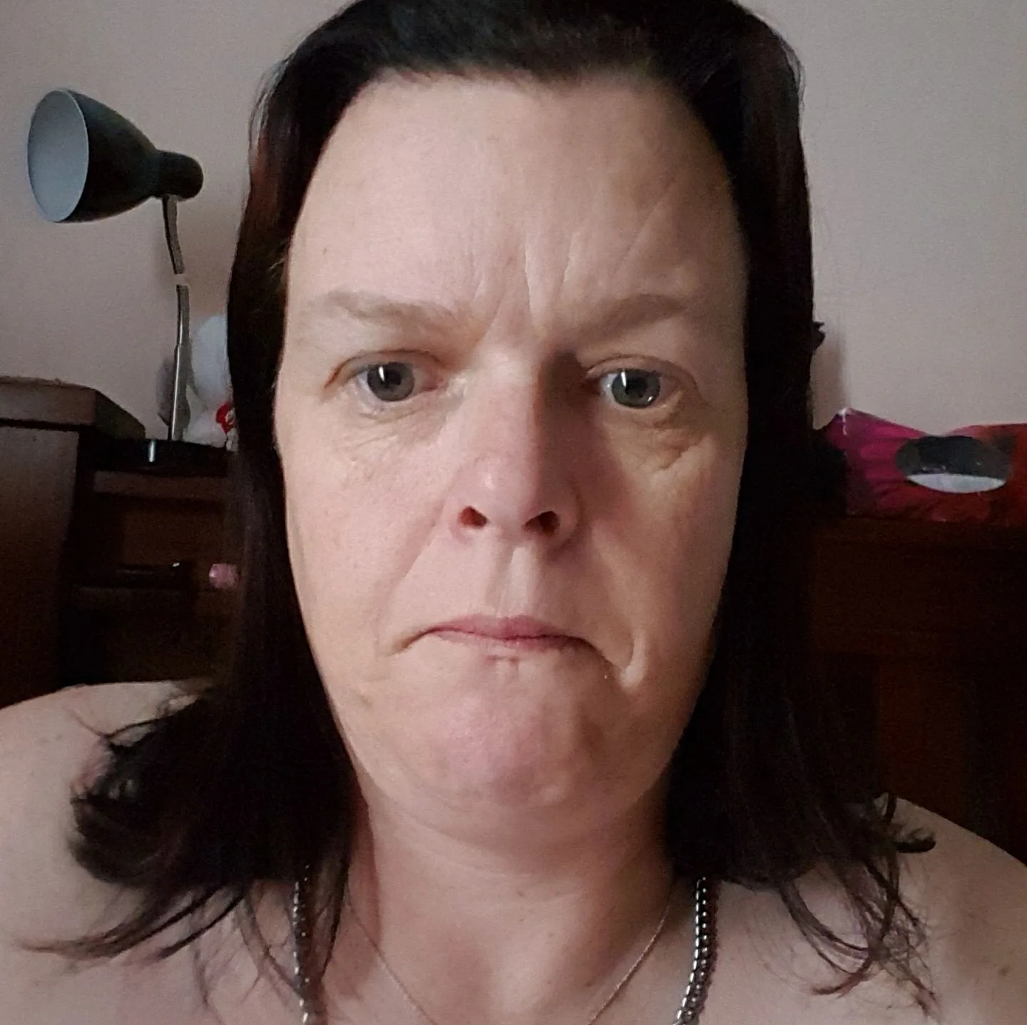 woman with brown hair taking selfie