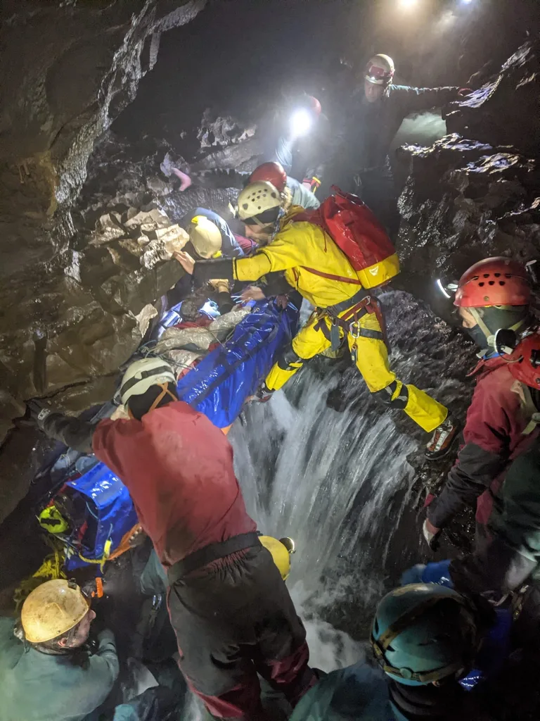 cave rescue team in yellow and blue outfits pictured amongst the caves.