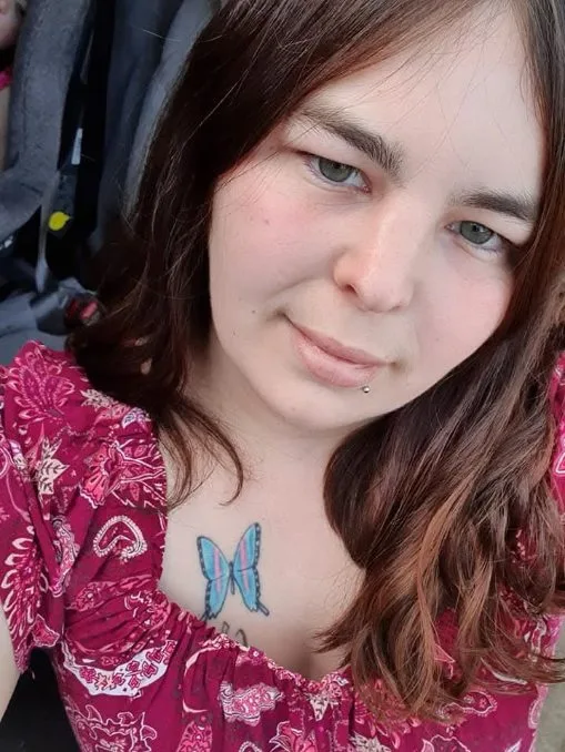 woman in red dress with blue butterfly tattoo