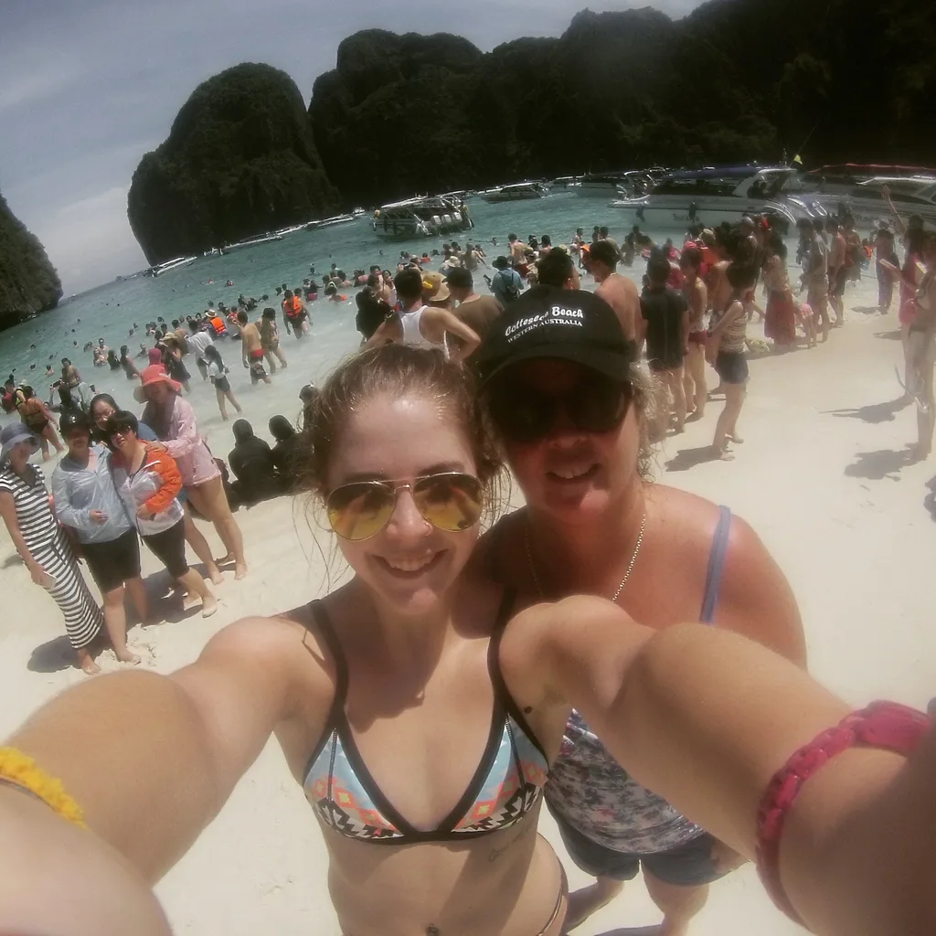 Tess and her mum in Thailand, two women in swimmers on a beach taking a selfie