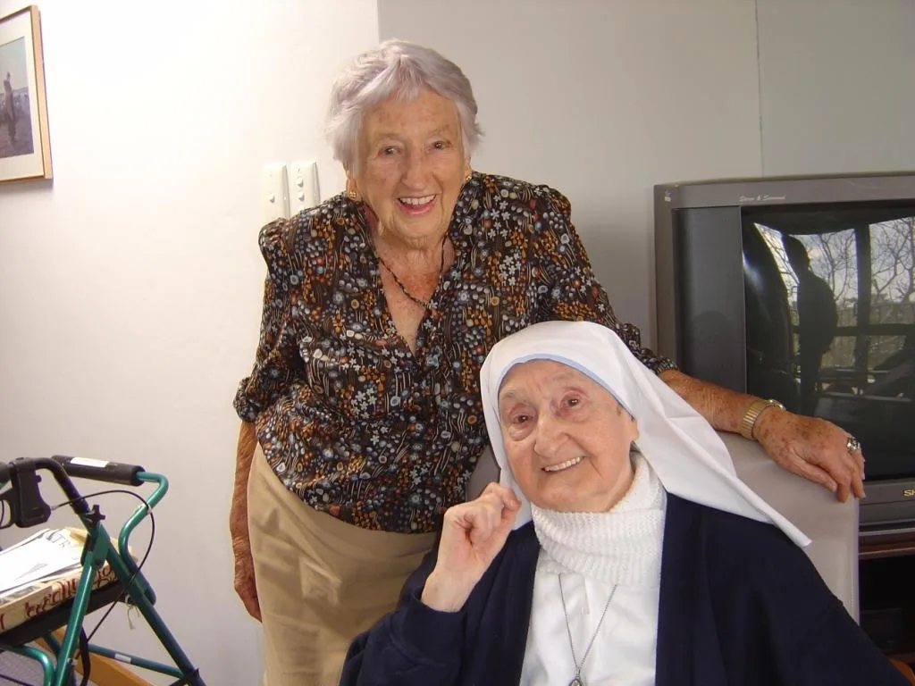 A nun and a woman standing