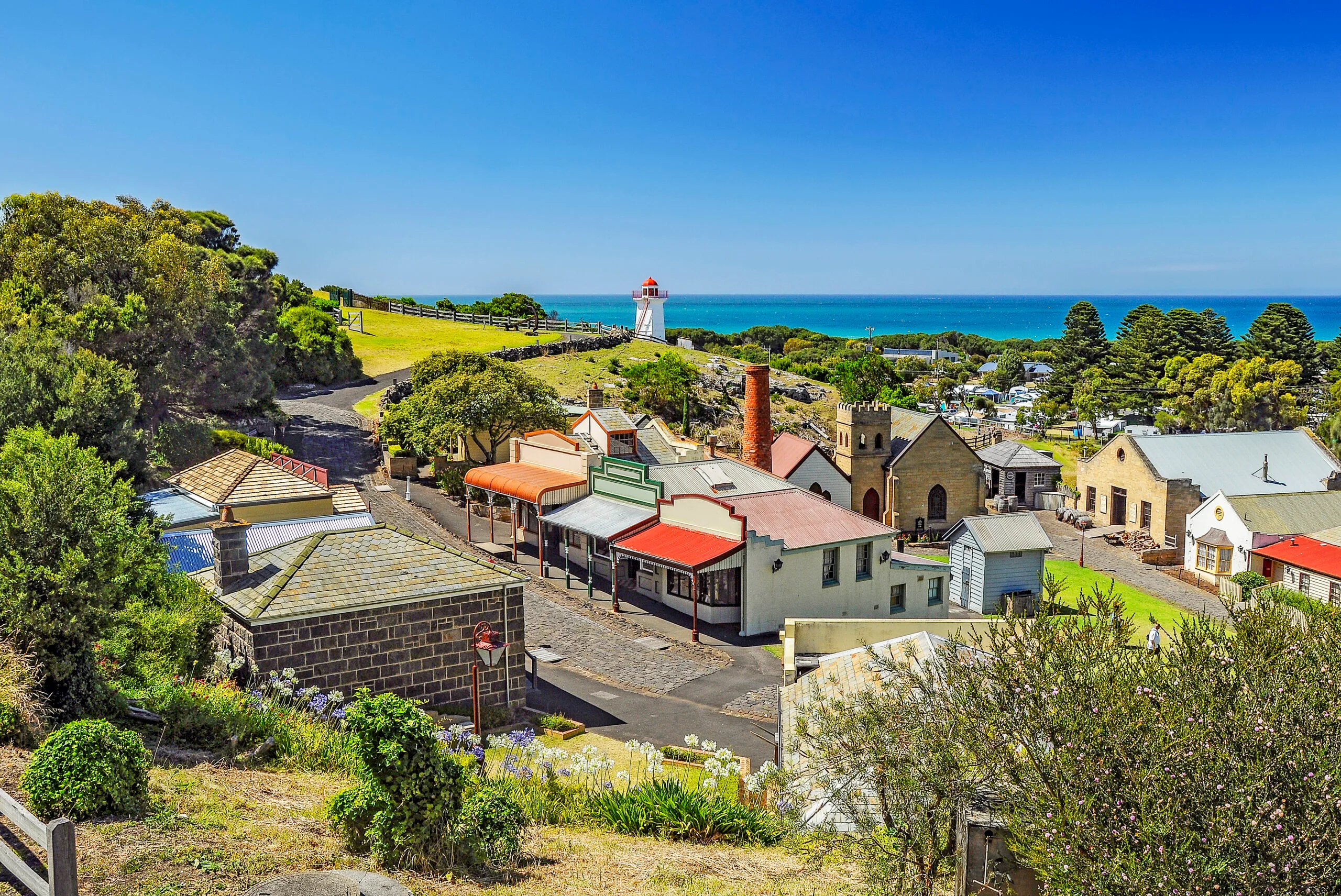 A photo of multicoloured buildings on a cobblestone street