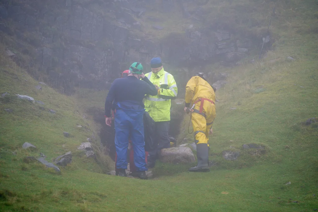 men in yellow waterproofs, blue waterproofs, red waterproofs.