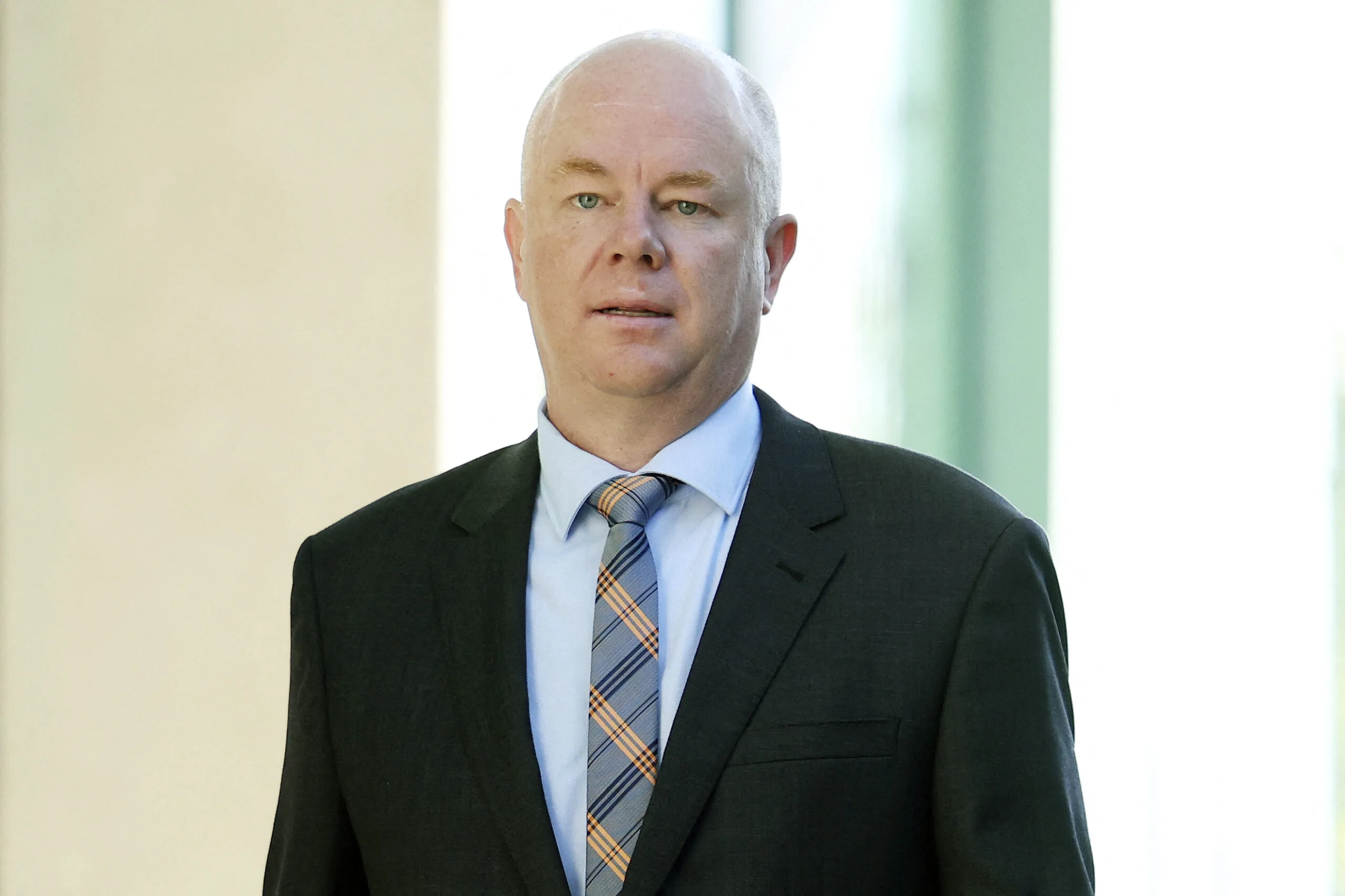man with black suit and blue tie