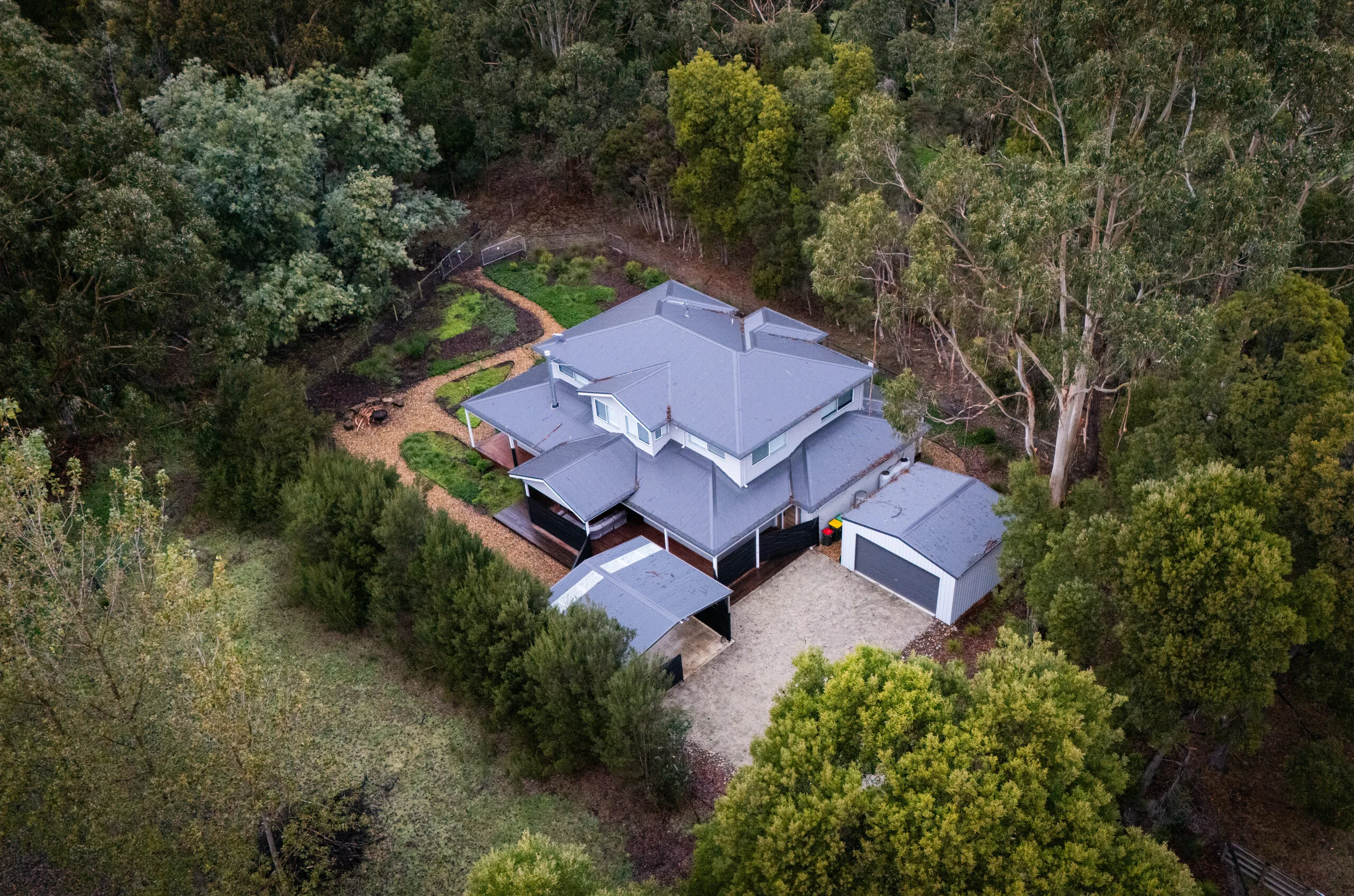 home from aerial view among trees