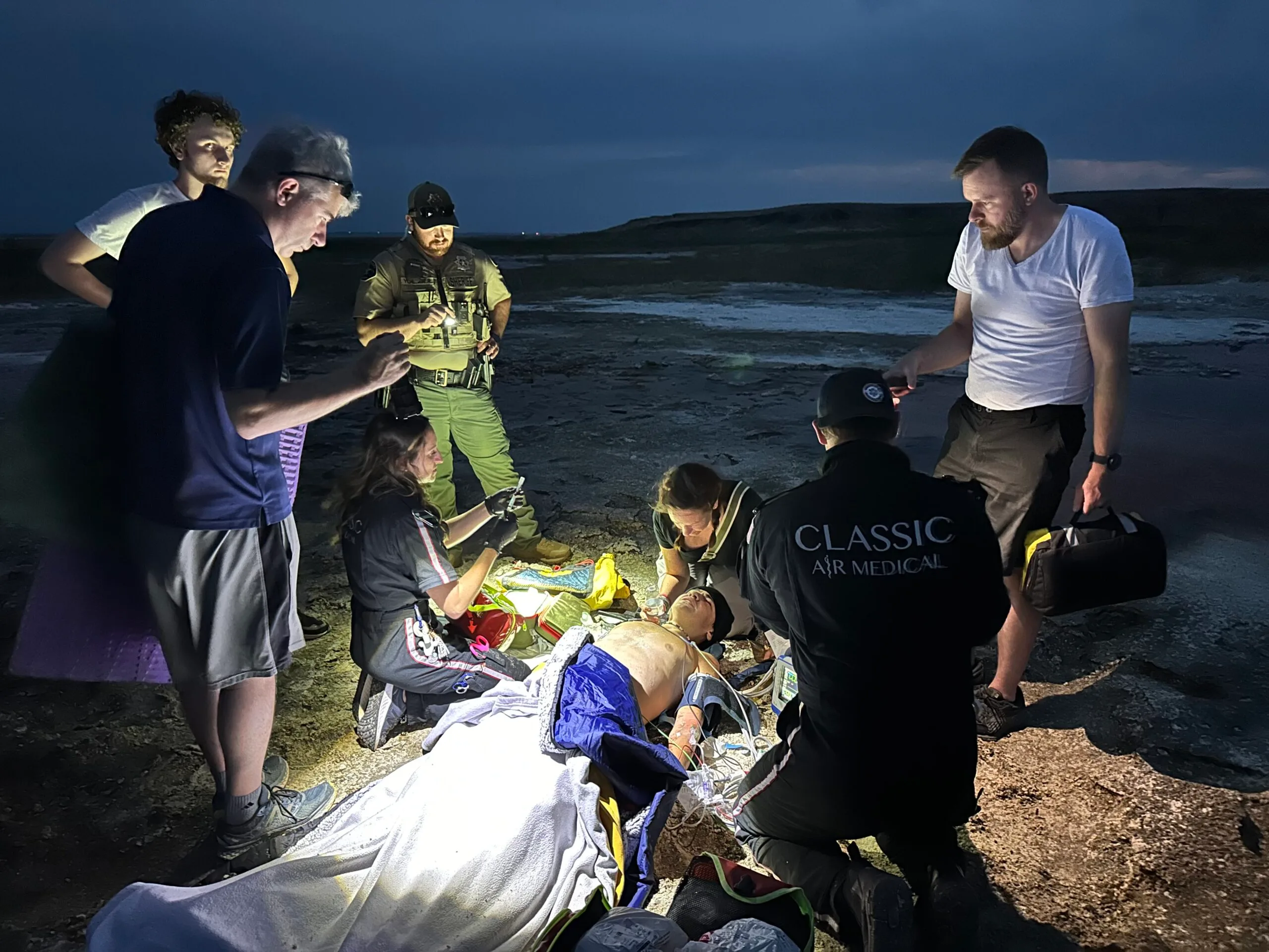 boy on stretcher covered in blankets, surrounded by medical team