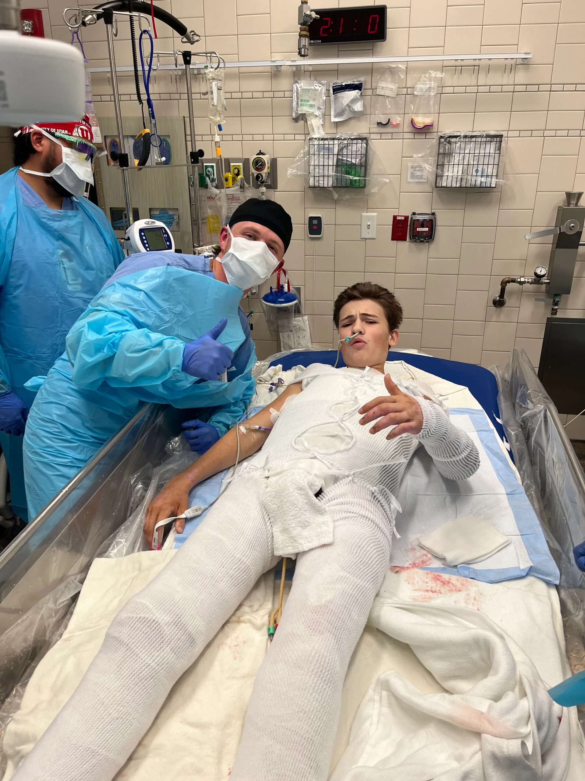 Boy wrapped in white bandages with a nurse