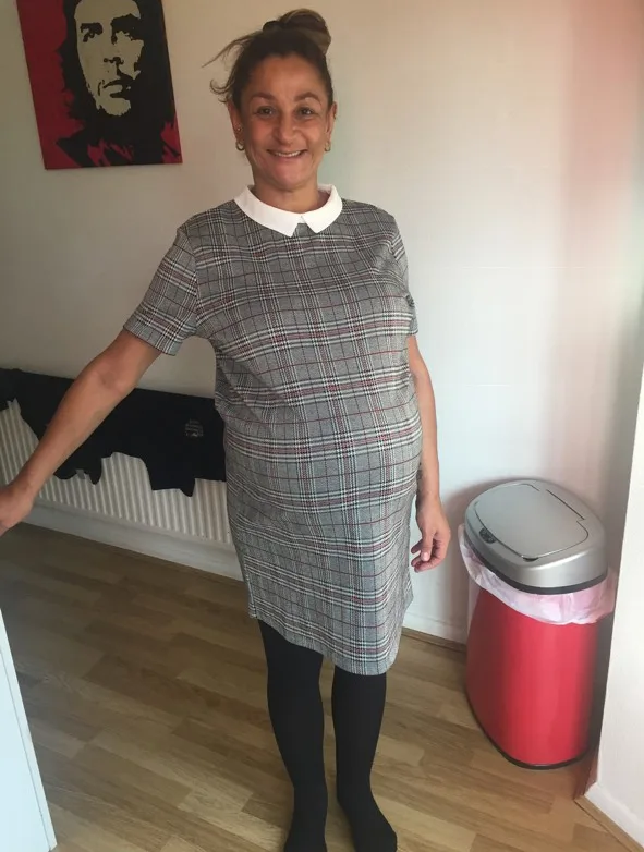 woman in grey check dress with large baby bump