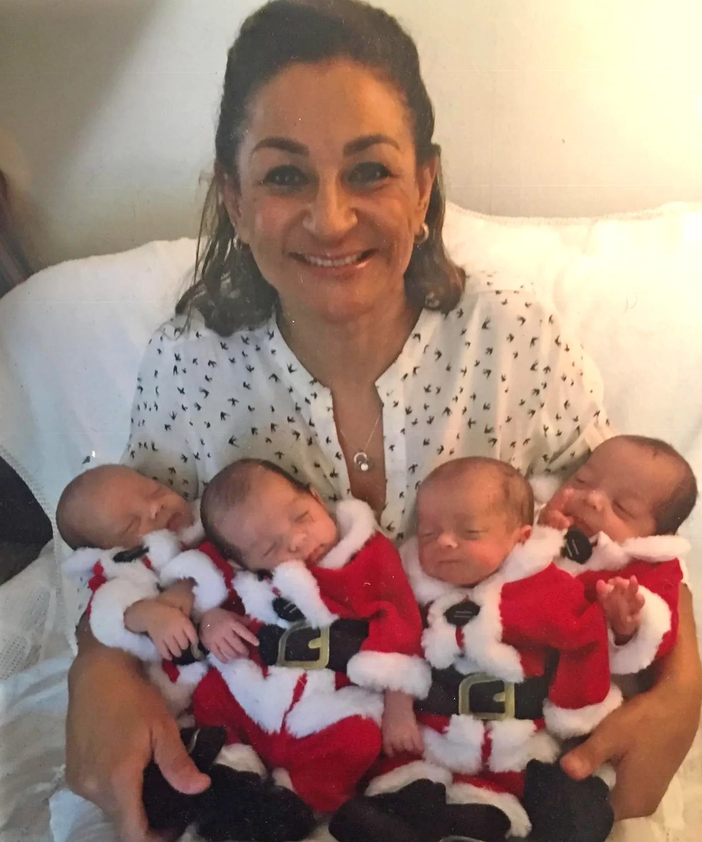 four babies in mini santa suits