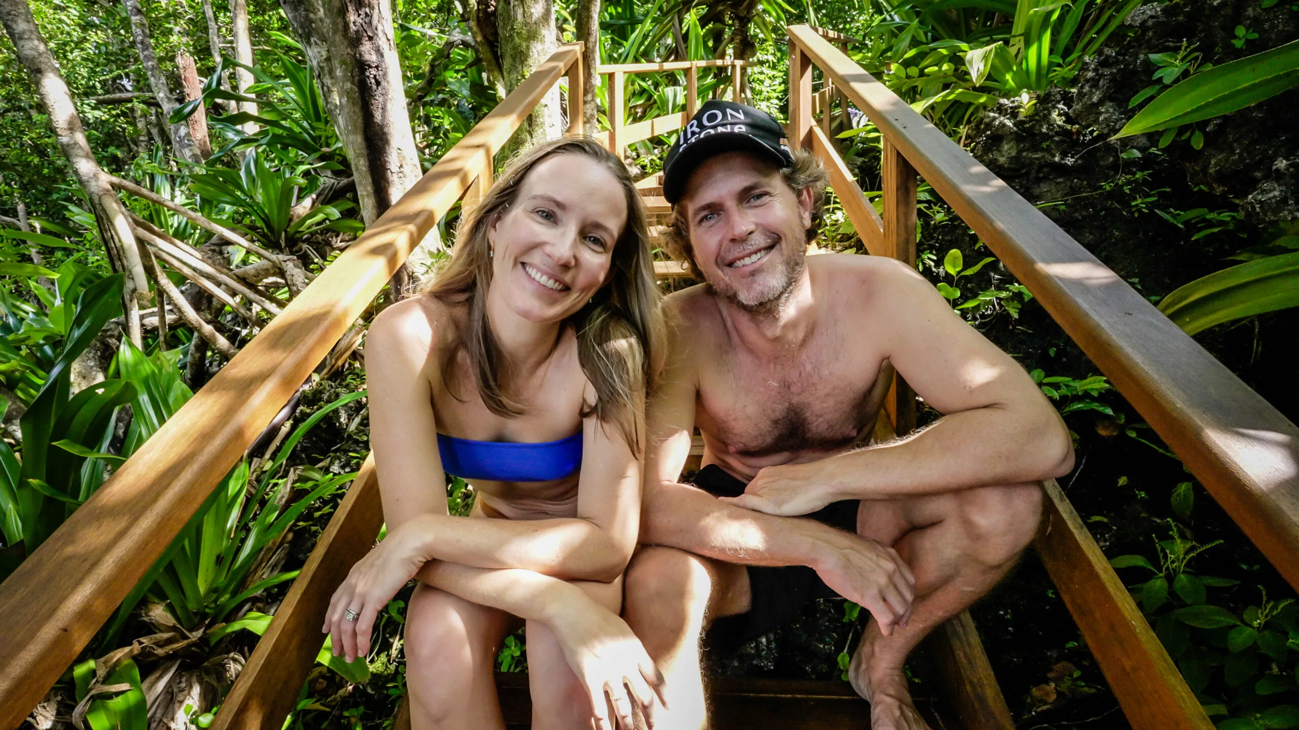 Woman and man on island smiling at camera.