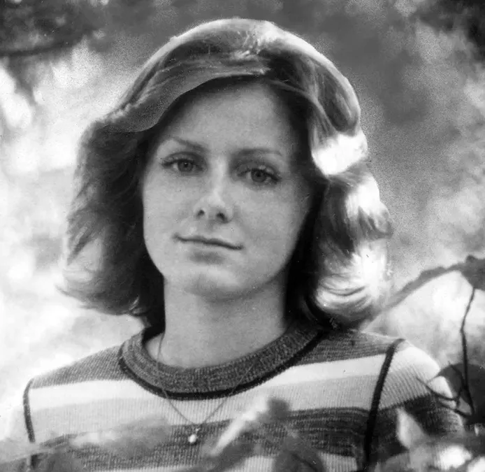 woman in striped shirt photo is black and white 