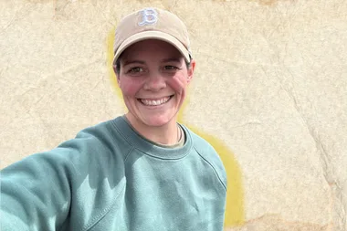 A woman outside in nature, smiling