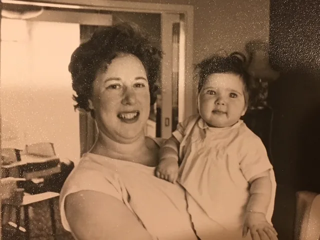 An old photo of a woman holding a baby