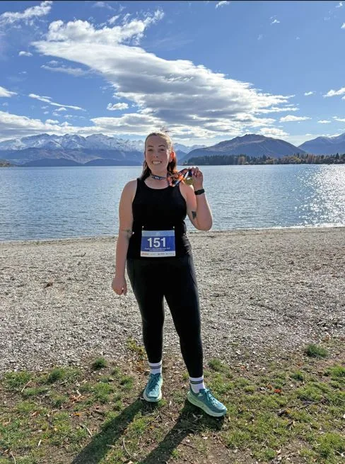 Image of woman at the beach after completing a half marathon