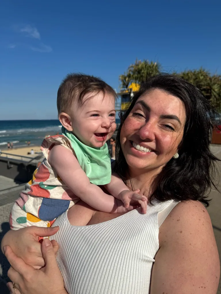 Image of woman holding toddler daughter