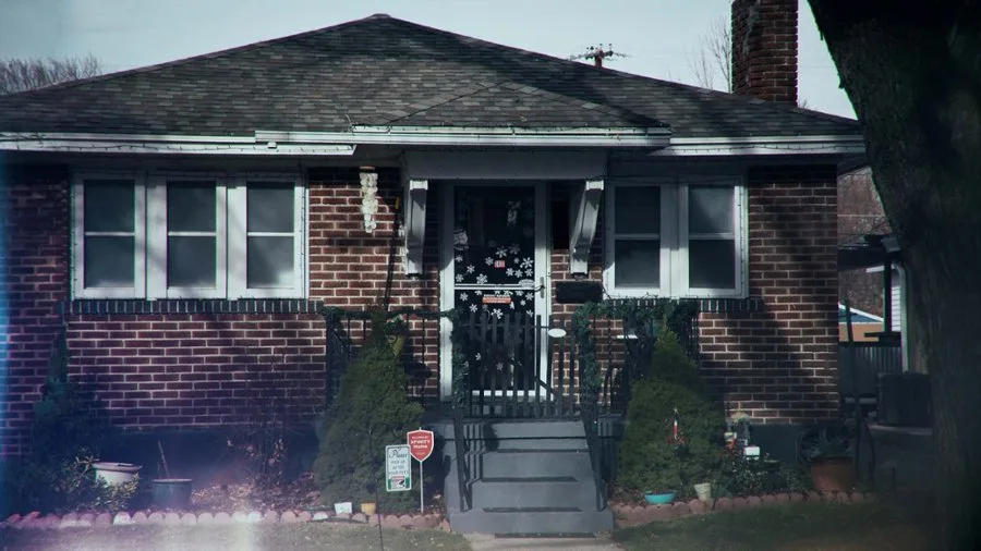 a brown brick house with white trim