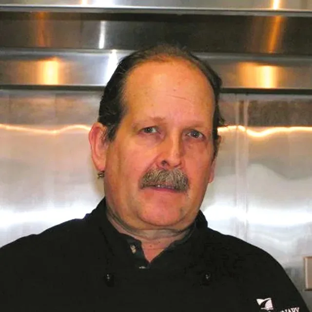 A close-up of a man with a moustache