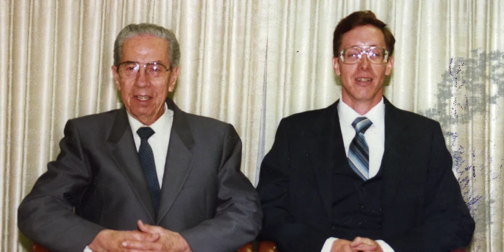 Two men in suits sitting down