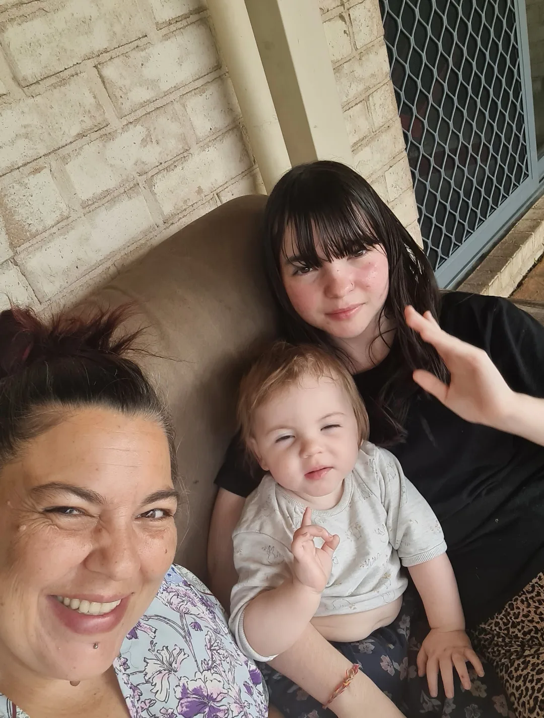 mum taking selfie of her, young child and other daughter 