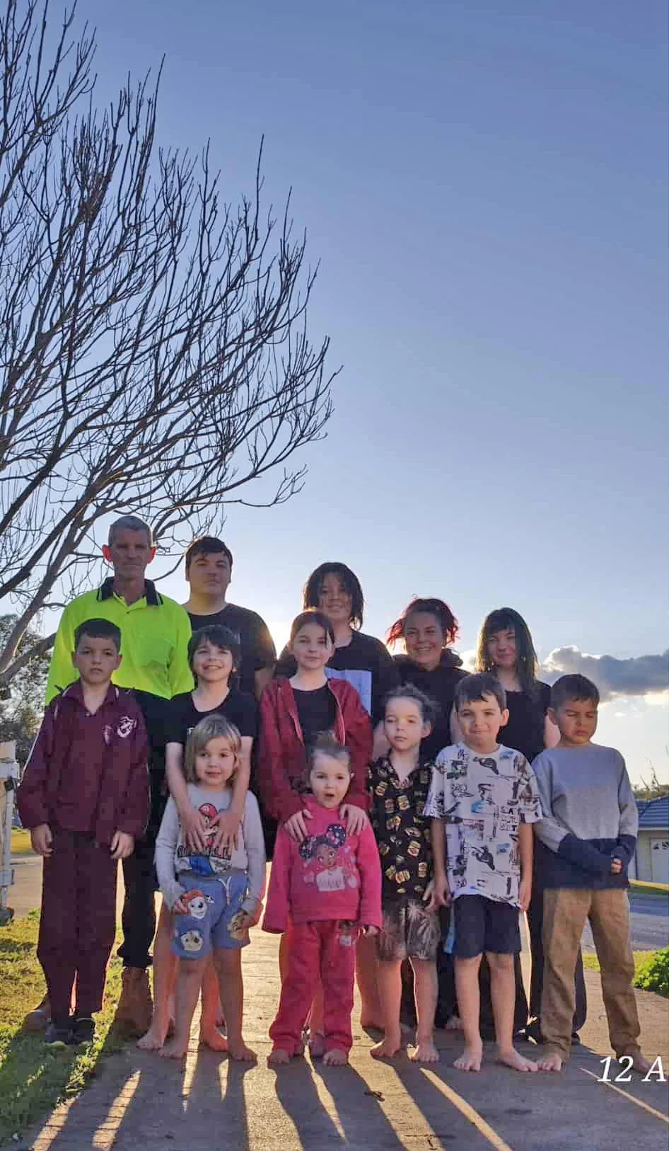 a large family standing outside 