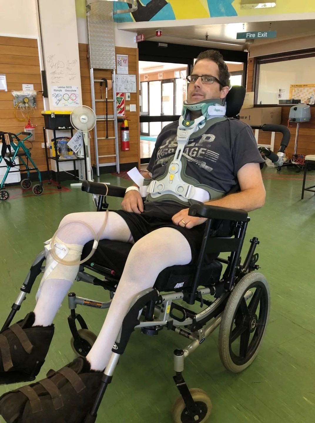 Man in wheelchair with neck brace