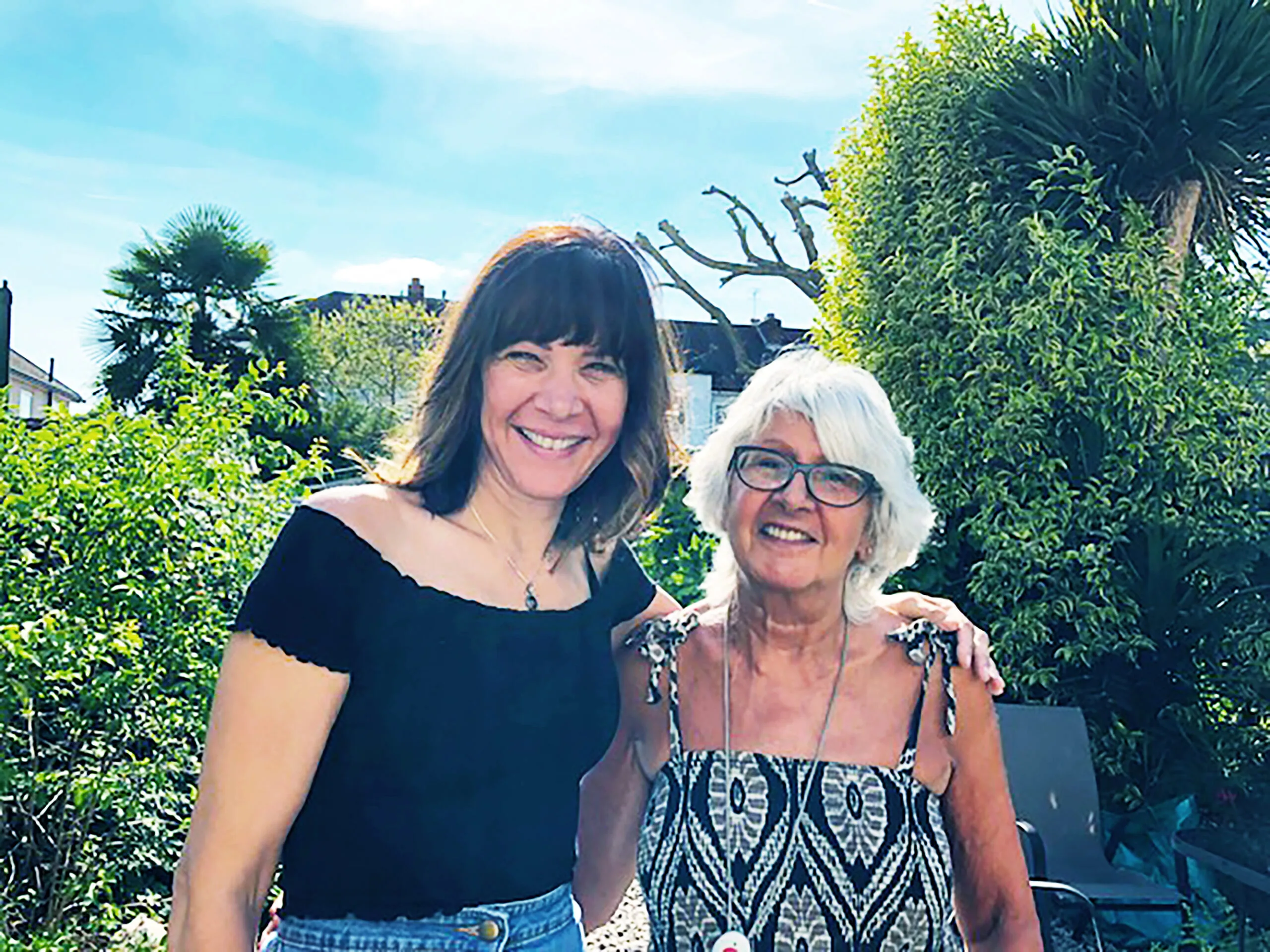 Zara and her birth mother Pat smiling outside