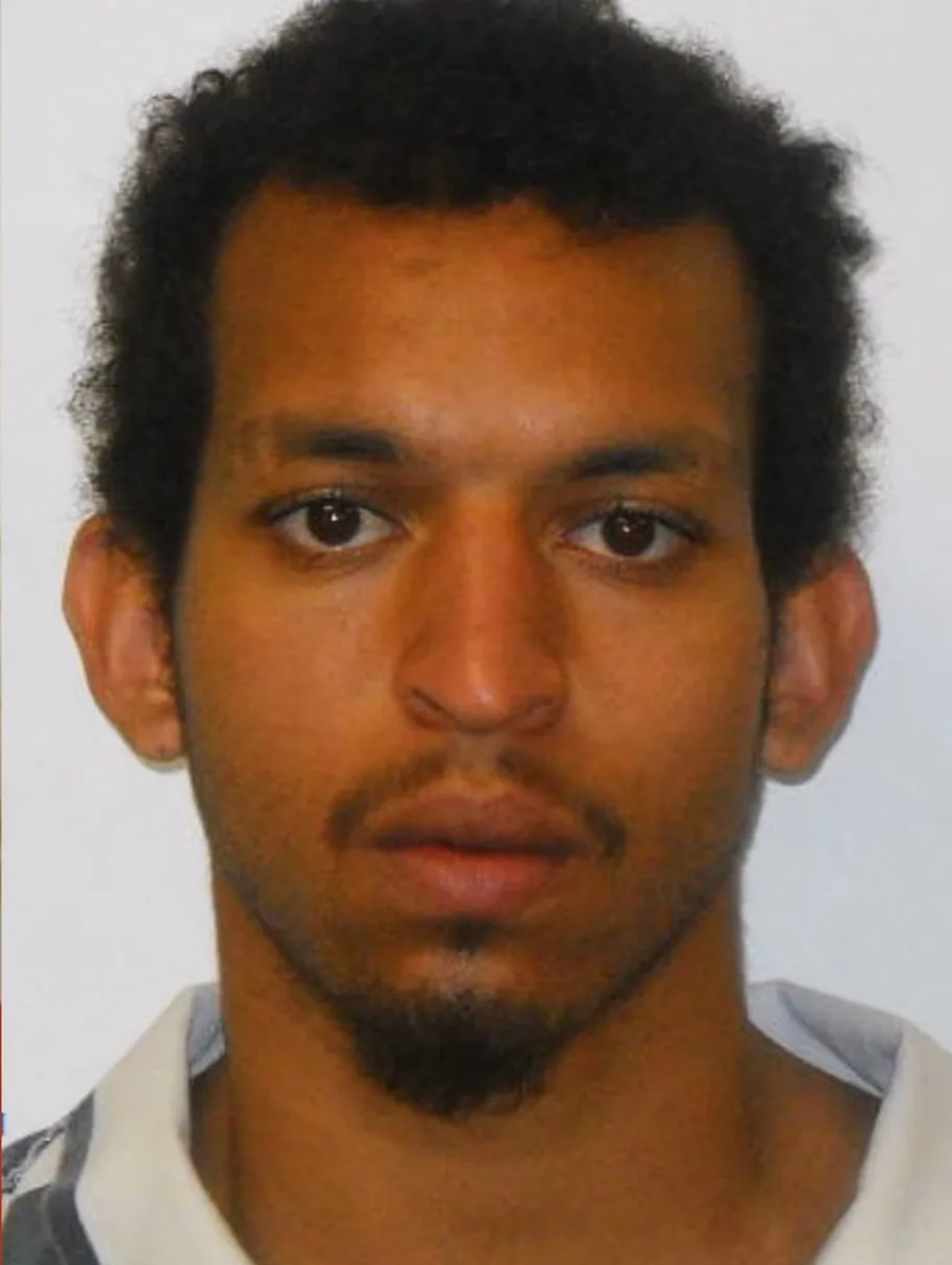 man mugshot he is tan and has brown hair