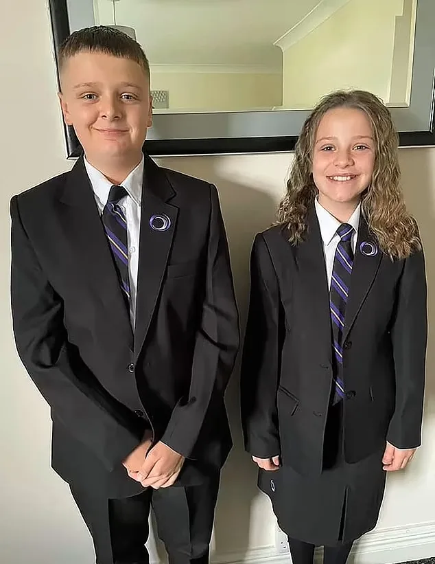 Two children in school uniform smiling at camera.