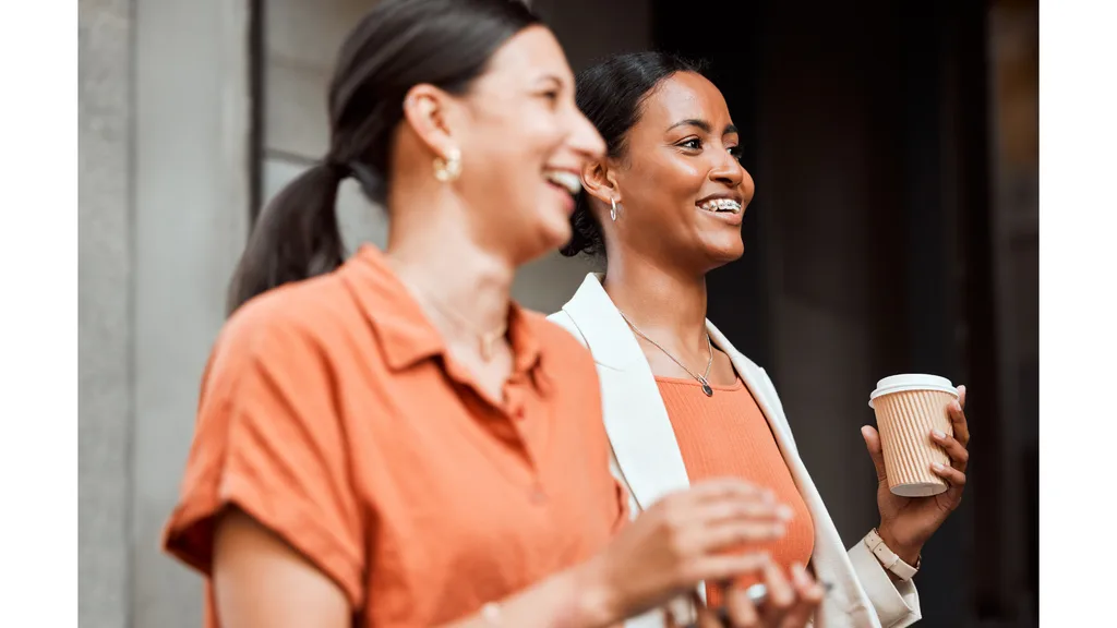 Two women enjoy a coffee run during a work break.