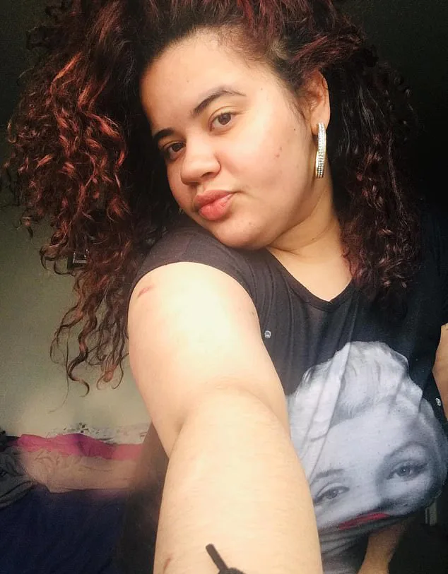 woman taking selfie she has curly hair and is pouting