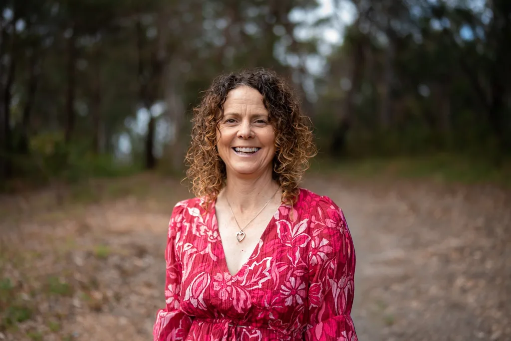 Louise Ginn wearing a pink outfit and smiling outside