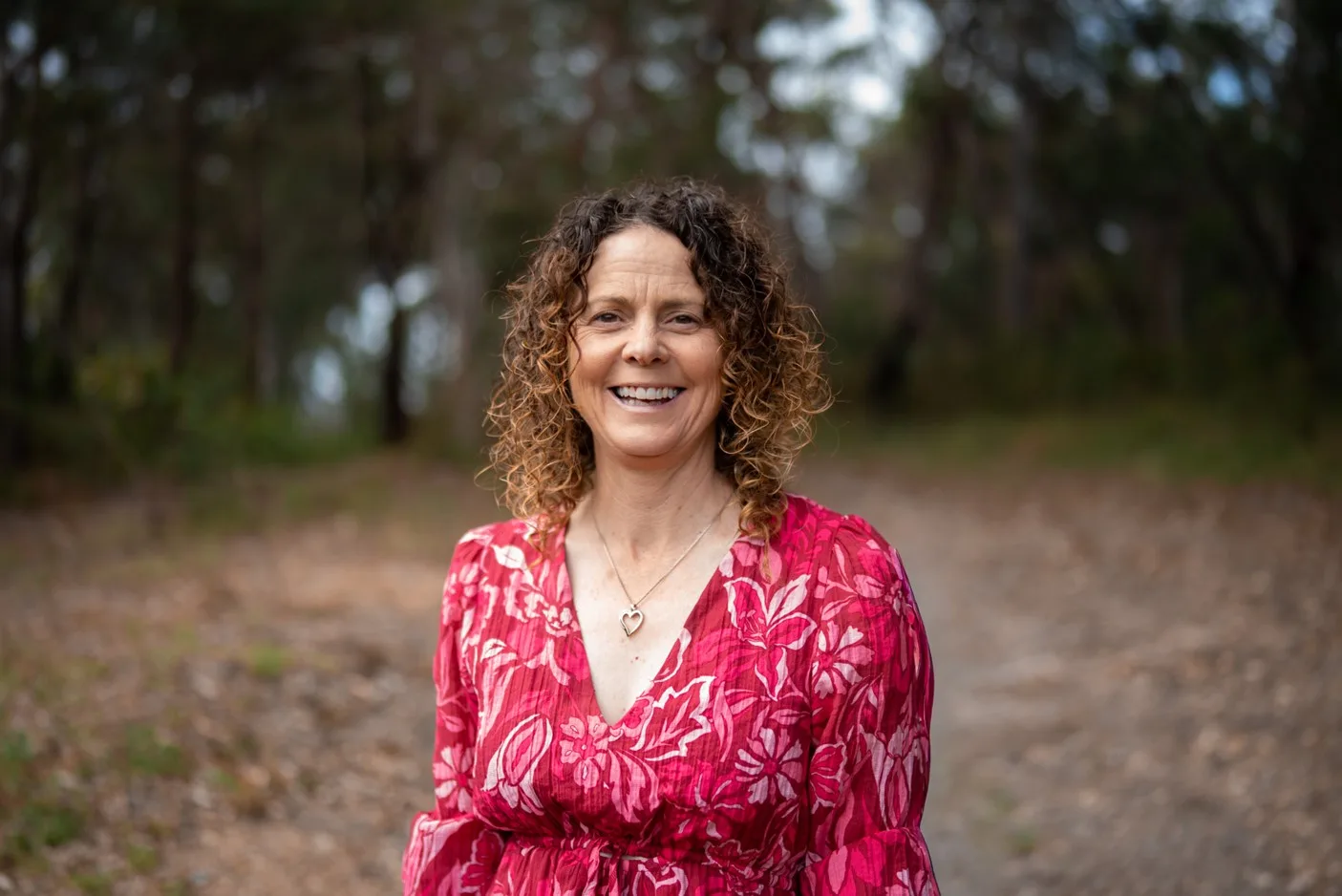 Louise Ginn wearing a pink outfit and smiling outside
