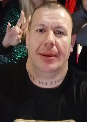 A man with a tattoo on his neck