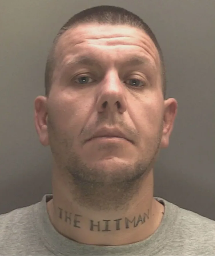 A man with a tattoo on his neck