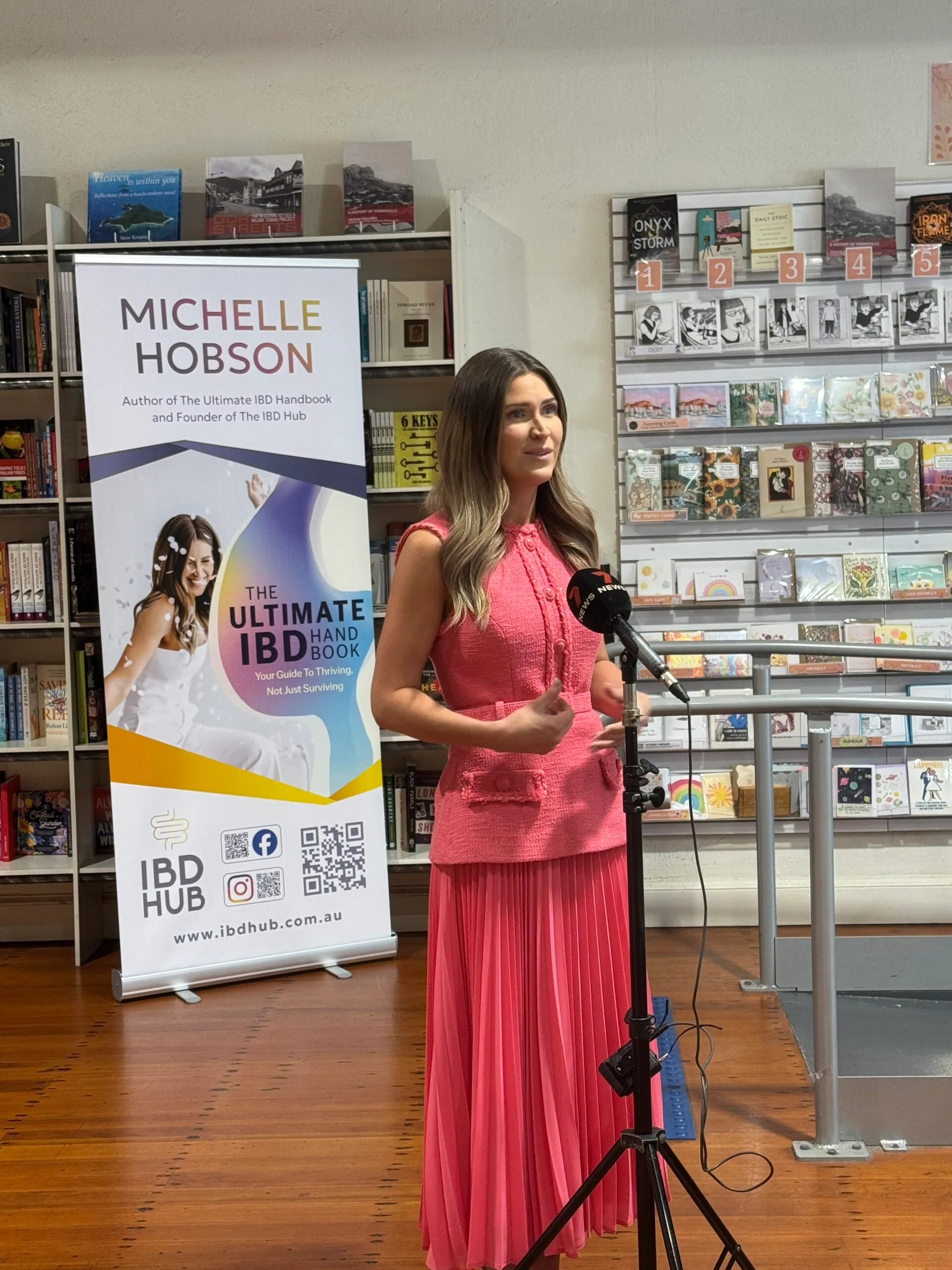 woman in pink standing in front of microphone 
