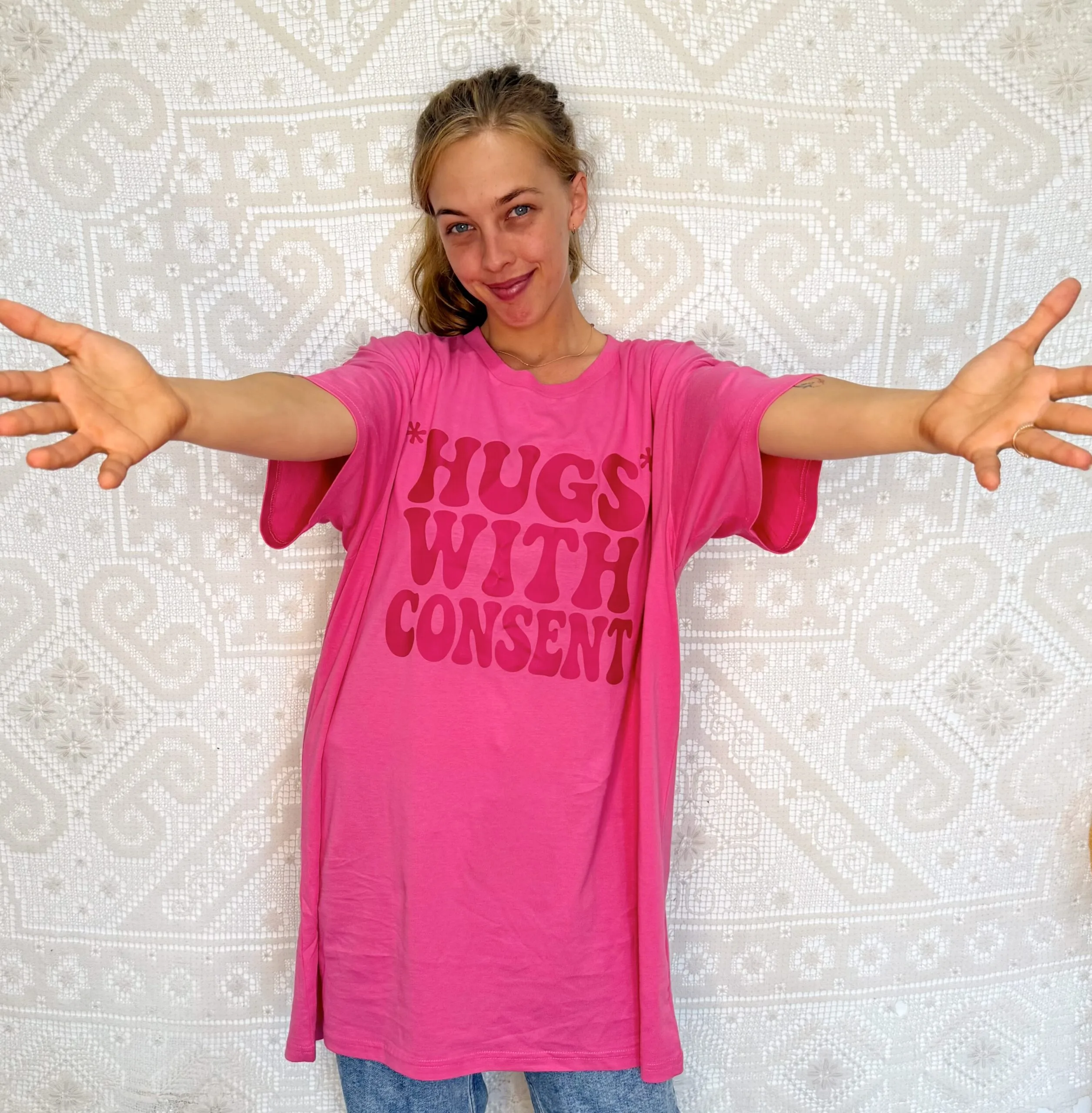 woman wearing shirt that reads 'hugs with consent'