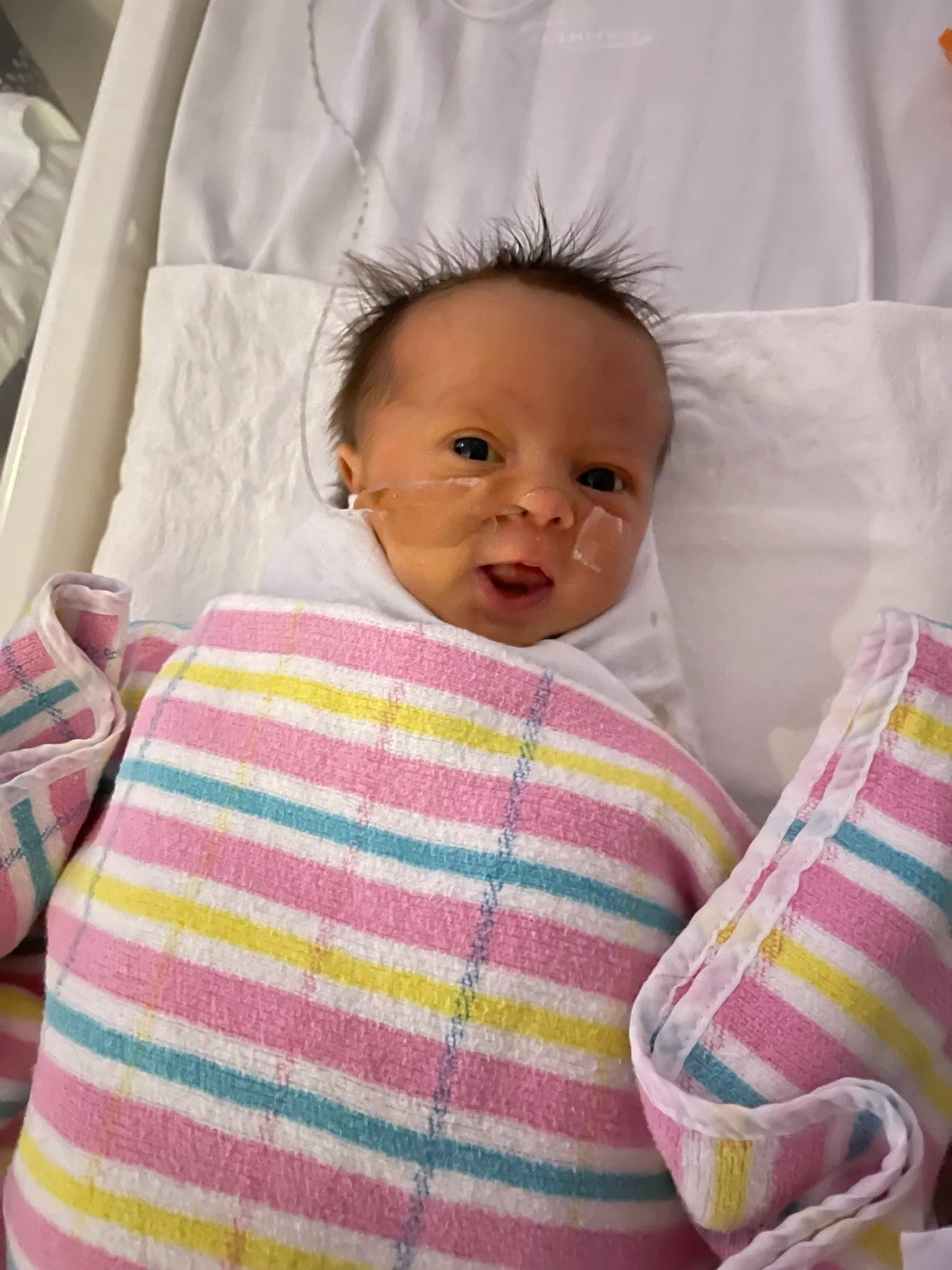 Image of newborn wrapped in hospital blanket