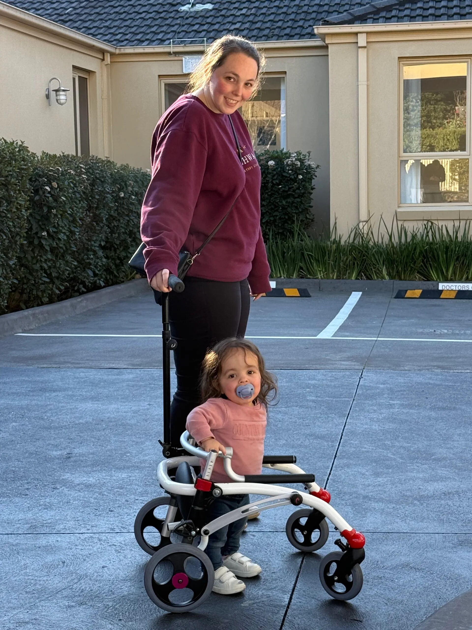 Image of mother and daughter, daughter using a posterior walker
