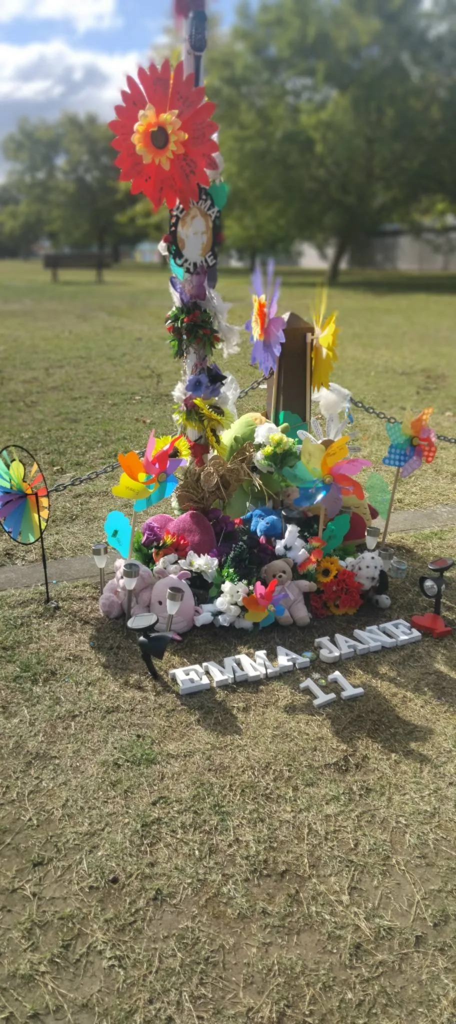 flowers and gifts left on grass edge