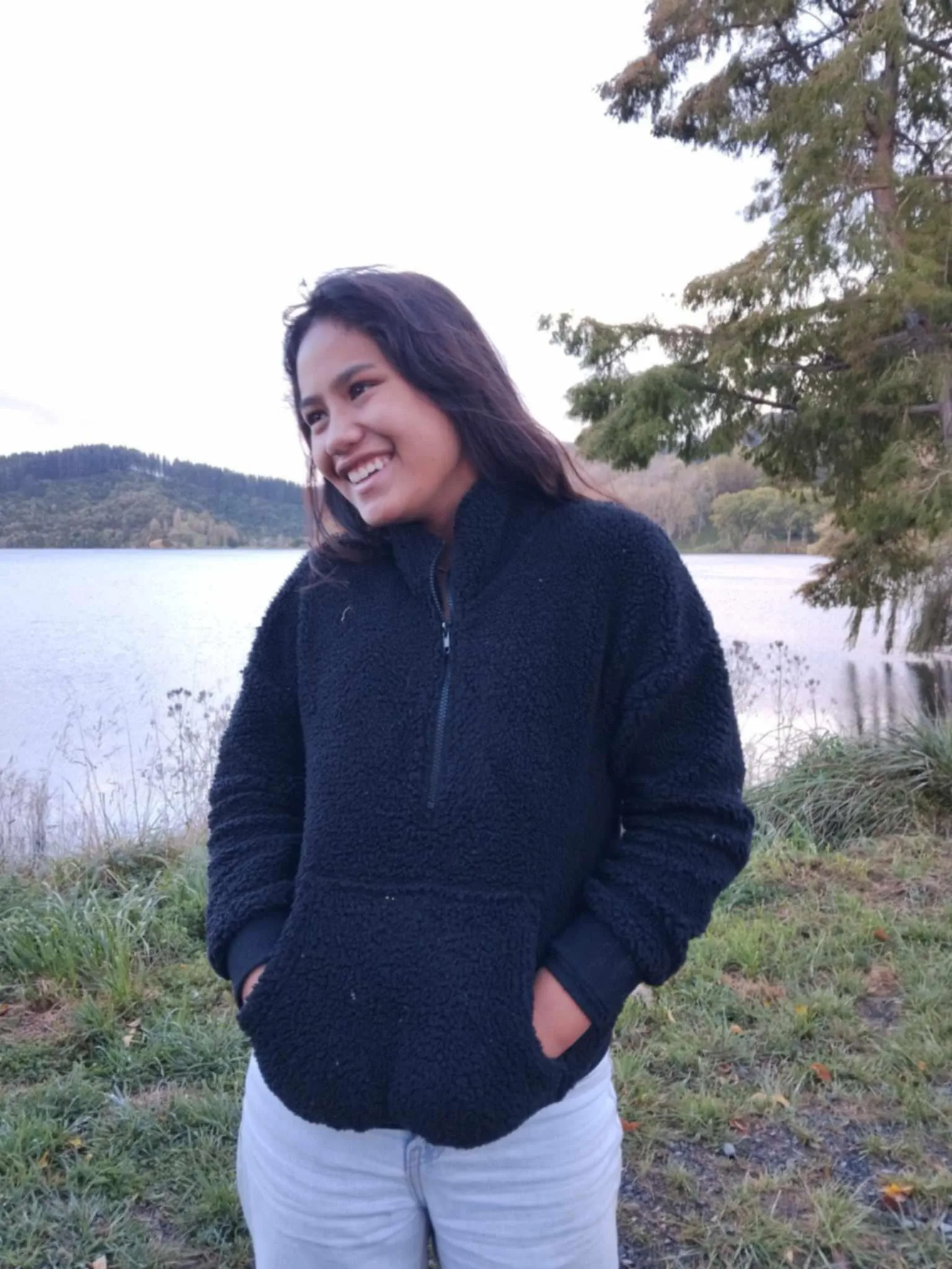 tween girl wearing black fleece sweater smiling to the left