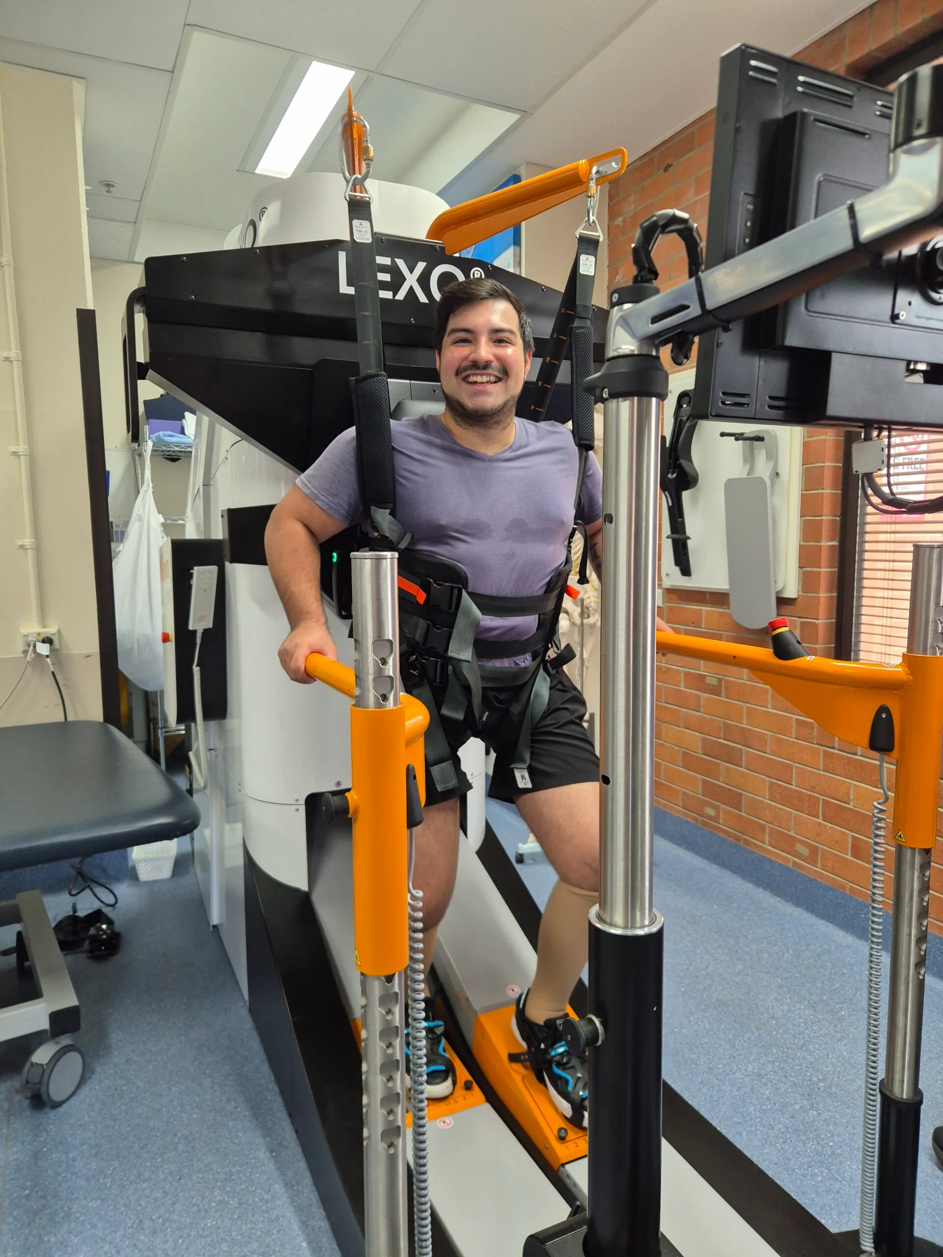 man strapped into machine standing upright