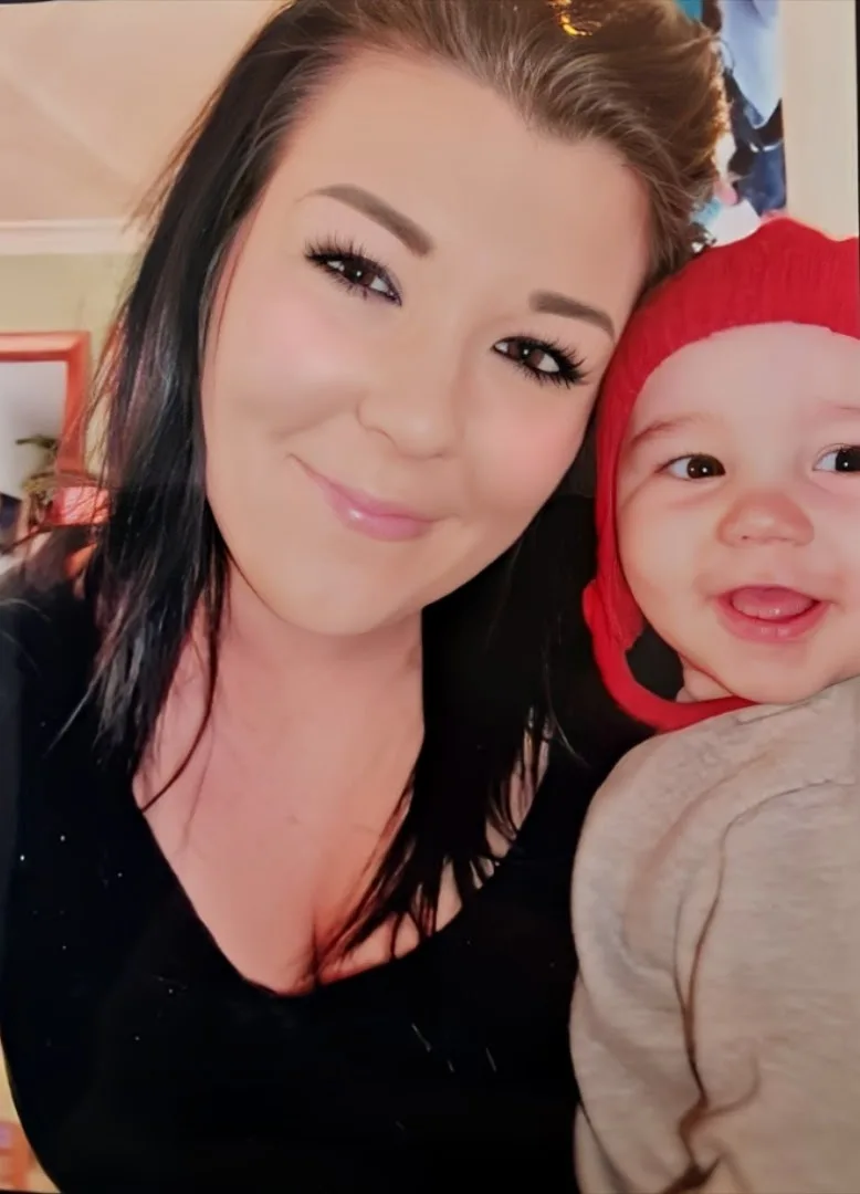 a brunette teen holds a baby